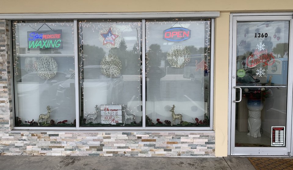 Clean nail salon interior with manicure stations.